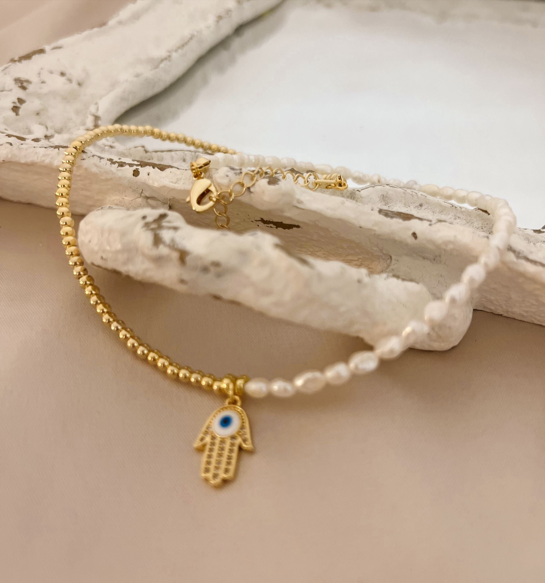 Gold Necklace with Half Pearl and Hamsa Hand Charm